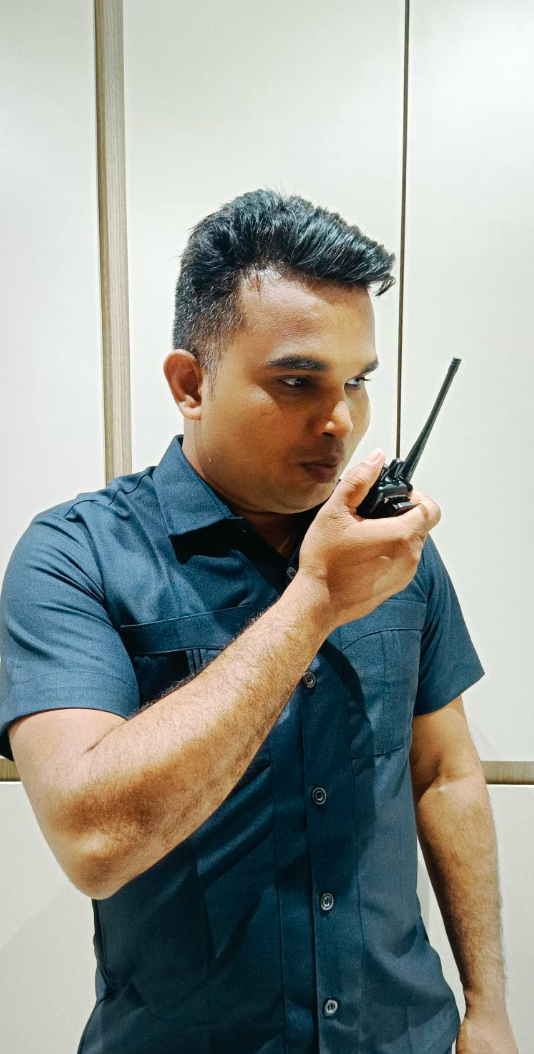 Perfect Group security guard on duty with a two-way radio